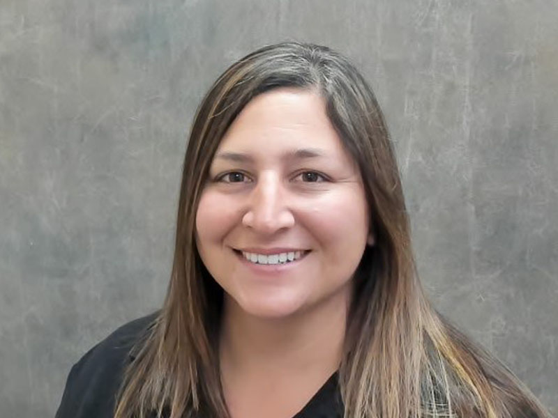 Brandy Thurman smiling in front of grey backdrop